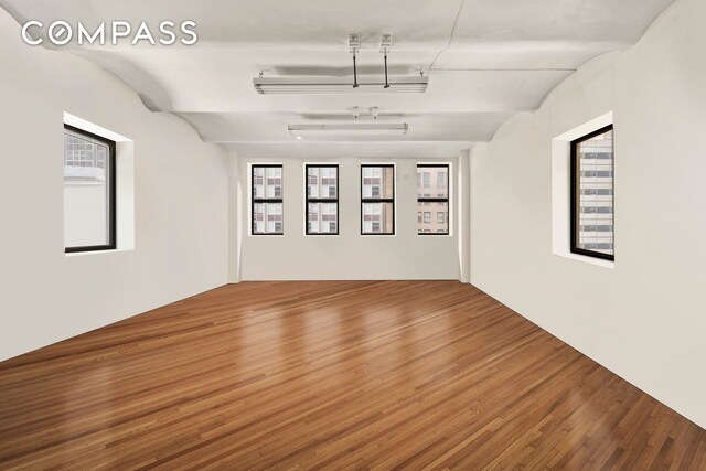 unfurnished bedroom featuring light hardwood / wood-style flooring and vaulted ceiling