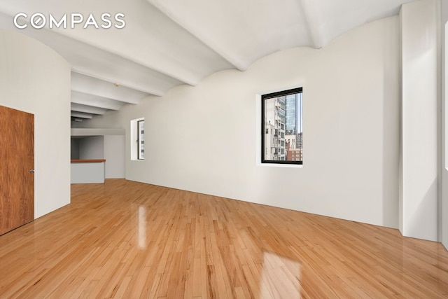 57 Warren St Unit 7, New York City, NY 10007 - unfurnished living room featuring hardwood / wood-style flooring and beamed ceiling
