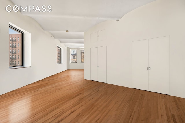 57 Warren St Unit 7, New York City, NY 10007 - spare room with lofted ceiling and wood finished floors