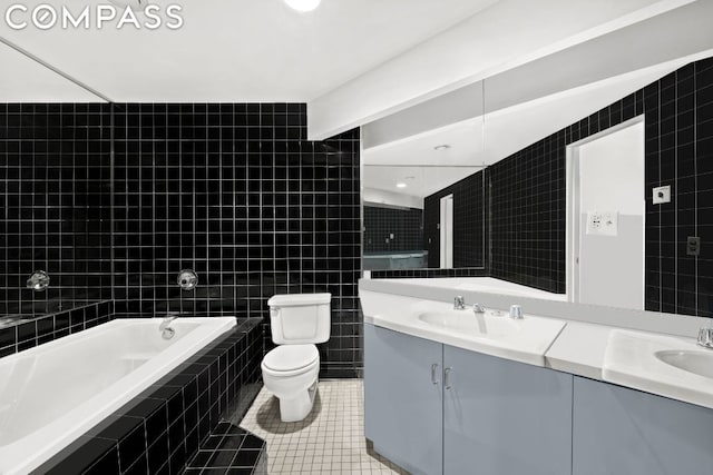 full bathroom featuring tile patterned floors, tile walls, and vanity