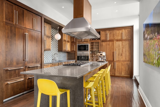 kitchen featuring a sink, built in appliances, dark wood-style flooring, and island range hood