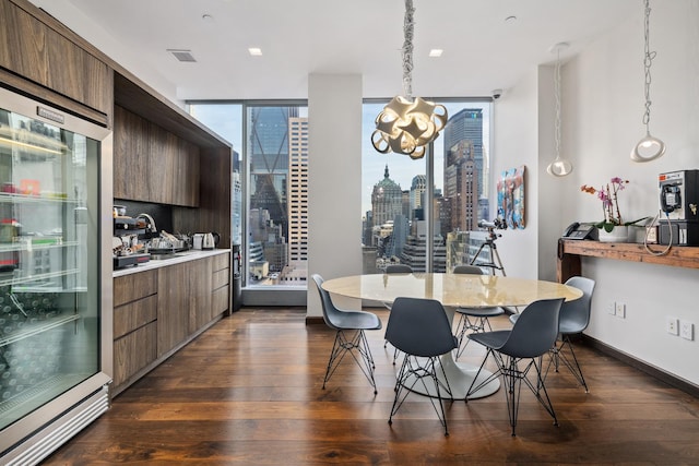 50 W 47th St Unit 1808, New York City, NY 10036 - kitchen featuring dark wood-style floors, light countertops, a chandelier, pendant lighting, and modern cabinets