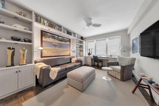 living room featuring ceiling fan, dark parquet floors, and built in features