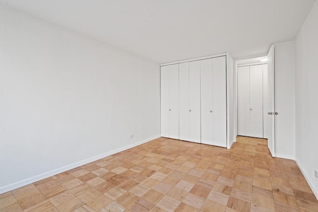 unfurnished bedroom with light parquet floors