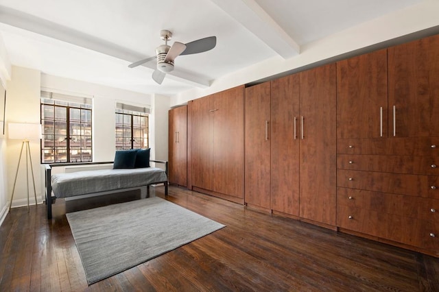 bedroom featuring ceiling fan, dark wood-type flooring, and beamed ceiling