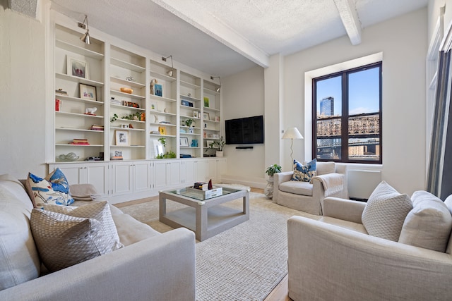 living room featuring a textured ceiling and beam ceiling