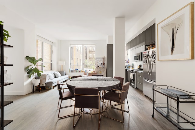 416 W 52nd St Unit 306, New York City, NY 10019 - dining room featuring light wood finished floors and baseboards