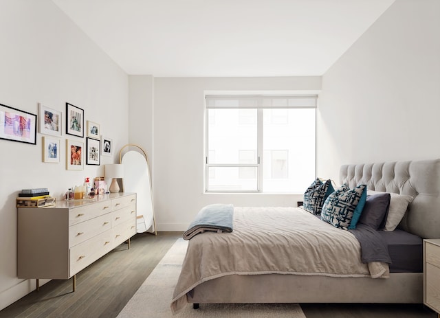 bedroom with wood finished floors and baseboards