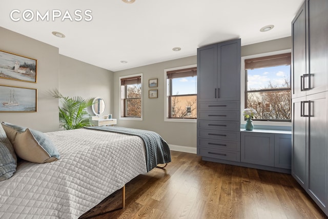 bedroom featuring baseboards and hardwood / wood-style floors