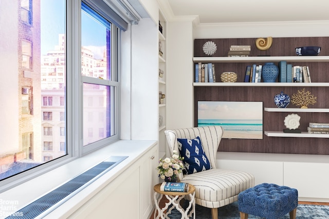 sitting room with ornamental molding and radiator heating unit