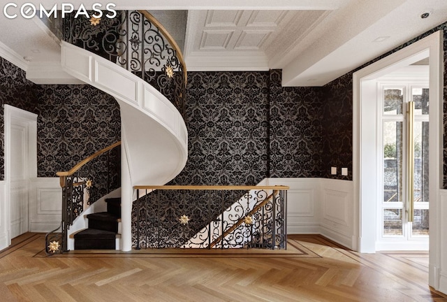 stairs featuring parquet floors and crown molding