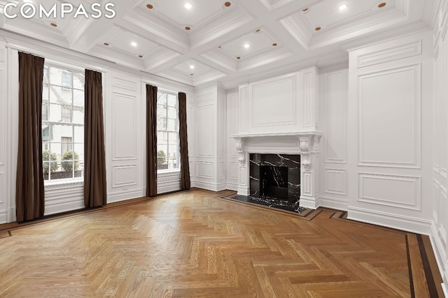 unfurnished living room featuring light parquet floors, a healthy amount of sunlight, a high end fireplace, and beam ceiling