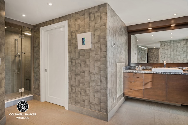 full bathroom with tile patterned flooring, double vanity, recessed lighting, a stall shower, and a sink