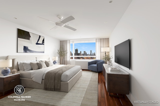 bedroom featuring wood finished floors and a ceiling fan