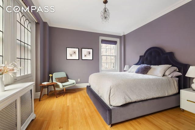 bedroom featuring hardwood / wood-style floors, ornamental molding, and radiator