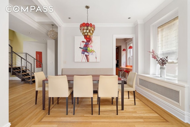 dining area featuring hardwood / wood-style floors and ornamental molding