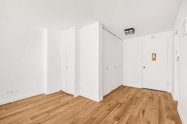 hall with light hardwood / wood-style floors