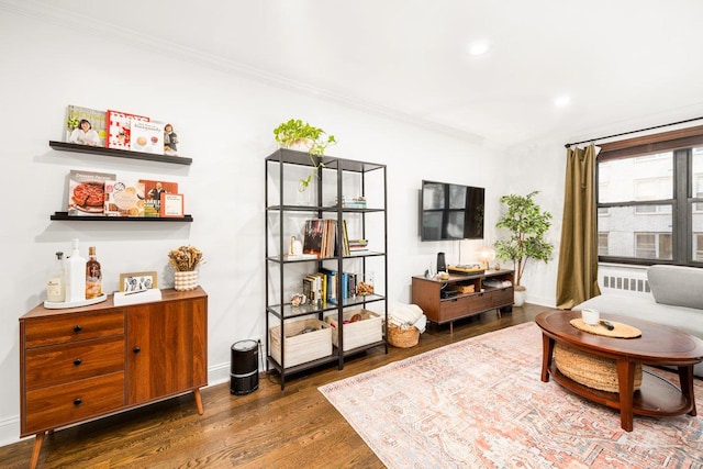 living area featuring recessed lighting, wood finished floors, baseboards, and ornamental molding