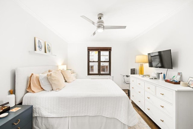 bedroom featuring ceiling fan, dark hardwood / wood-style flooring, and crown molding