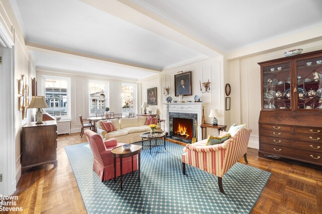 living room with dark parquet flooring, a fireplace, and beamed ceiling