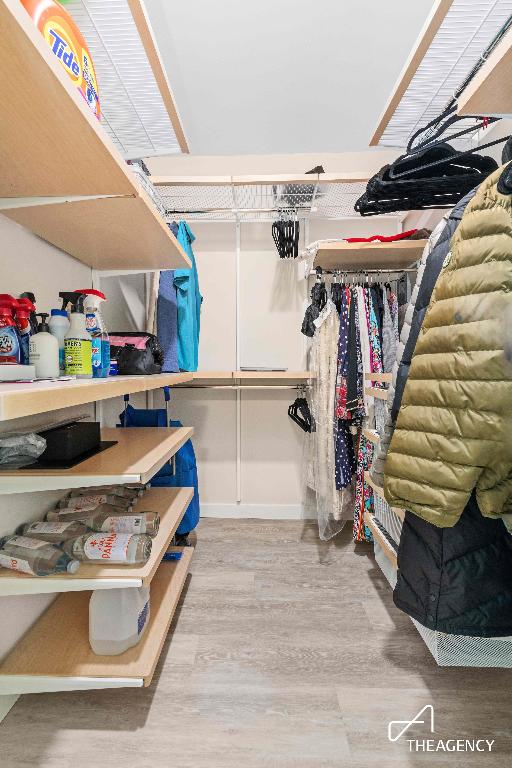 spacious closet with light hardwood / wood-style flooring