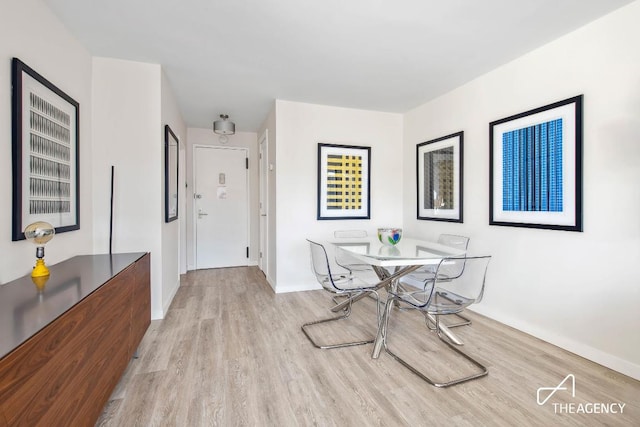 dining space with light wood-type flooring