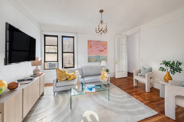 living room featuring wood-type flooring and a notable chandelier