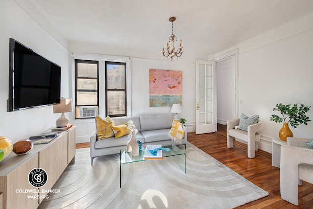 living room featuring wood-type flooring and a notable chandelier