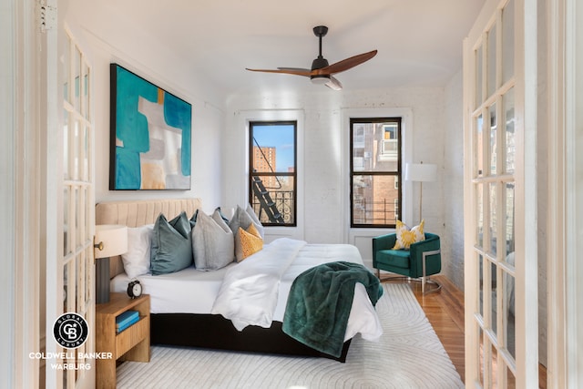 bedroom featuring french doors, ceiling fan, and light wood-type flooring