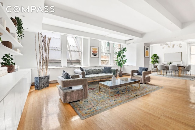 living room with hardwood / wood-style floors and beam ceiling