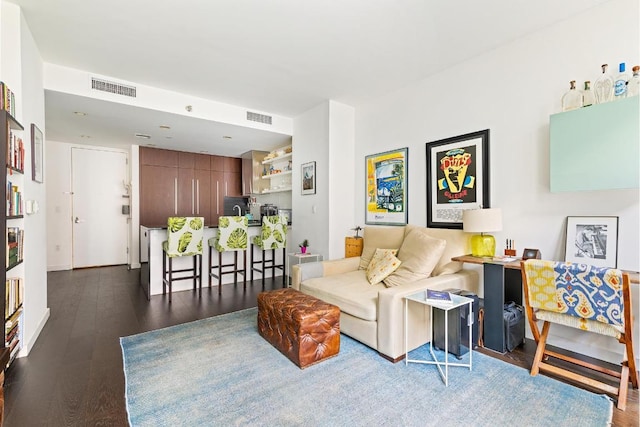 living room with dark wood-type flooring and visible vents