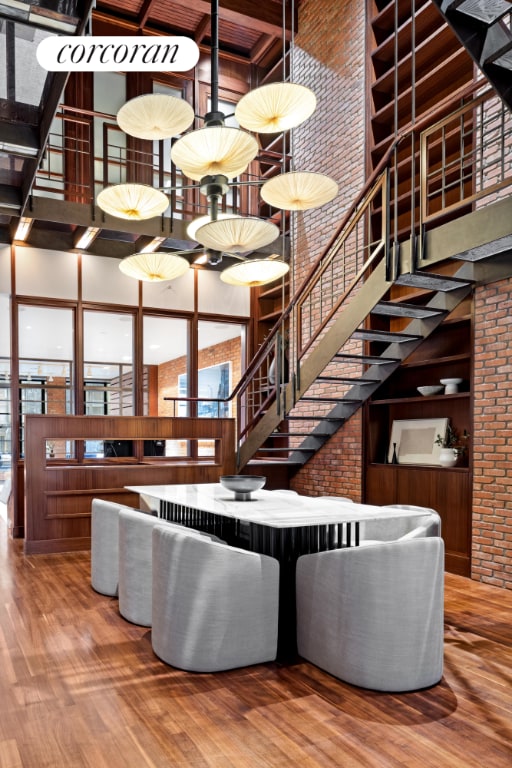 living room featuring wood-type flooring and a towering ceiling