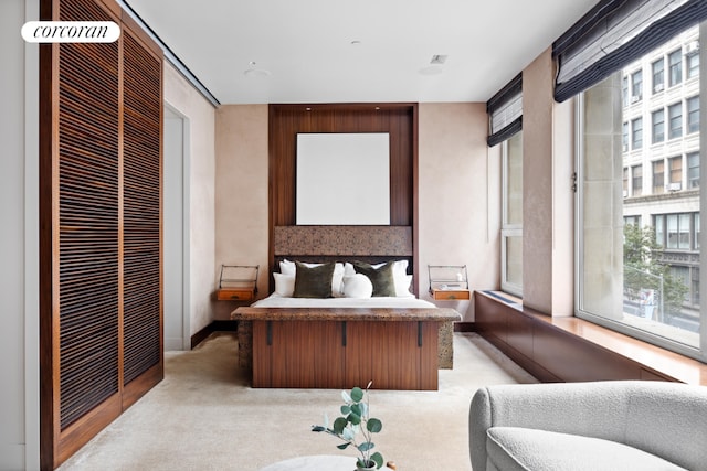 bedroom featuring light colored carpet