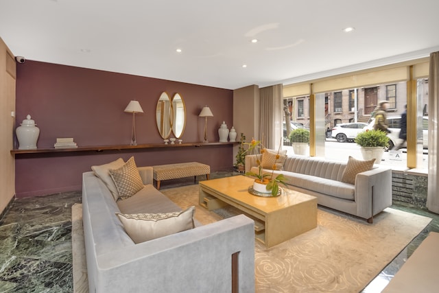 living area with recessed lighting and marble finish floor