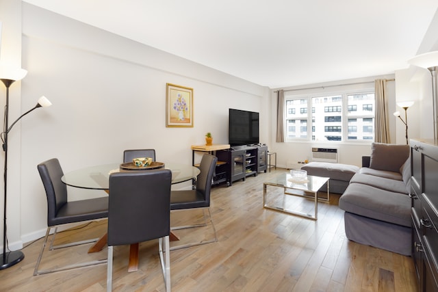 living area featuring light wood-style flooring and baseboards