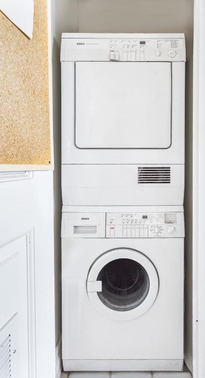 laundry room with stacked washer and dryer