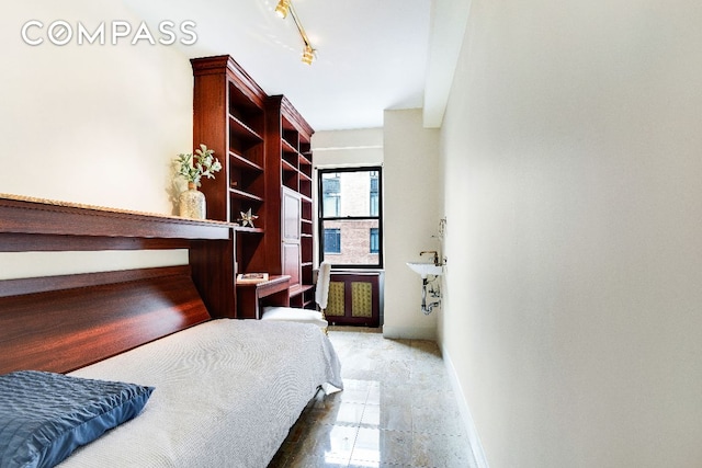 bedroom featuring rail lighting