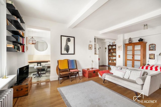 living room with wood finished floors and beam ceiling