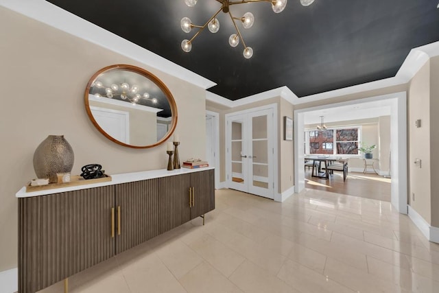 corridor with light tile patterned floors, crown molding, and french doors