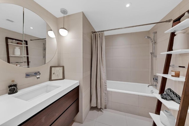 bathroom featuring tile patterned flooring, shower / bath combo, and vanity