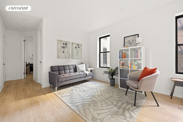 sitting room featuring wood finished floors, visible vents, and baseboards