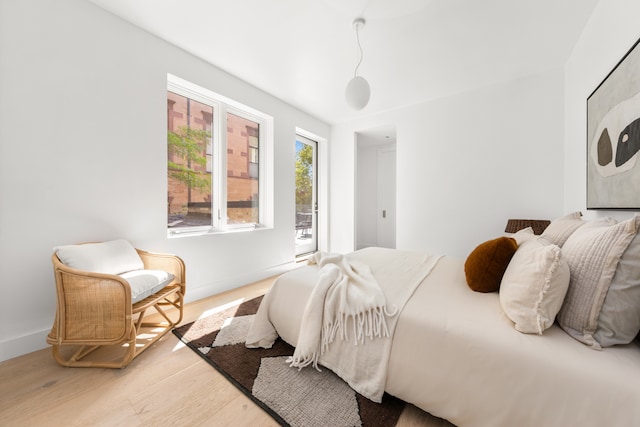 bedroom featuring wood finished floors and baseboards