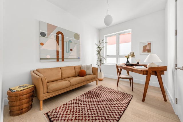 living area featuring baseboards