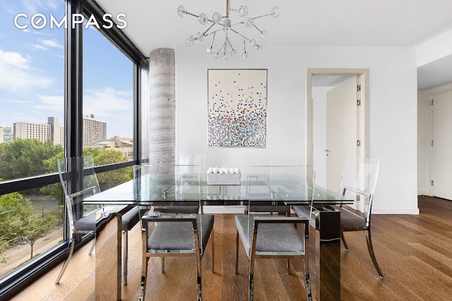 dining room with an inviting chandelier, wood-type flooring, and expansive windows