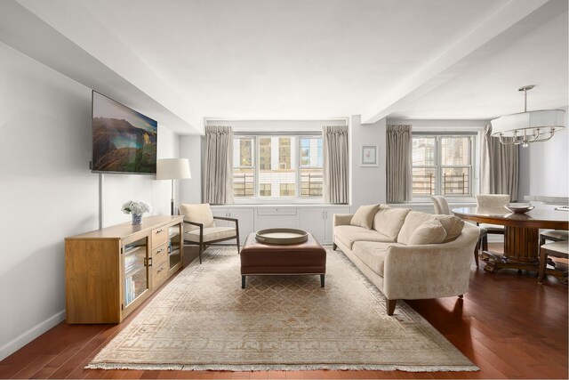 living room featuring a chandelier and dark hardwood / wood-style flooring