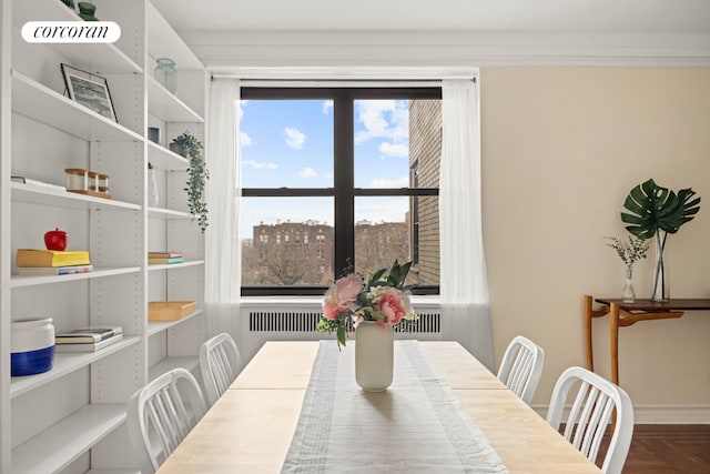 dining space featuring parquet floors