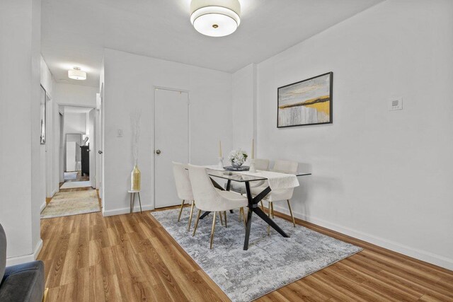 bedroom featuring radiator heating unit and light hardwood / wood-style floors