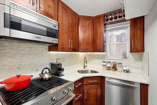 kitchen with tasteful backsplash, sink, and stainless steel appliances