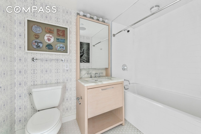 bathroom featuring toilet, tile patterned flooring, wallpapered walls, shower / bath combination, and vanity