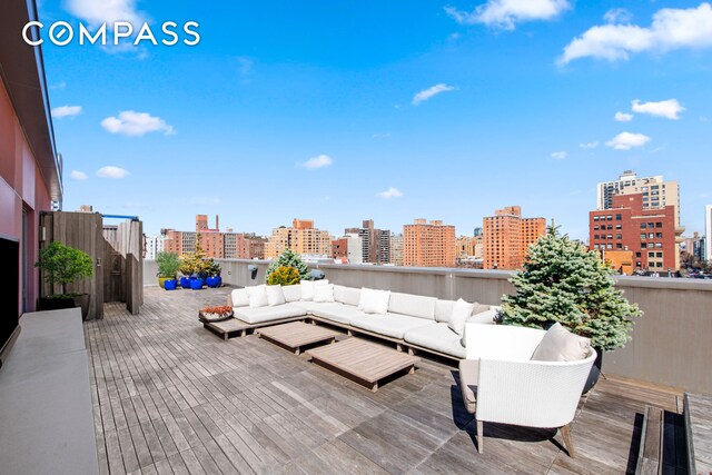 deck with an outdoor living space and a view of city